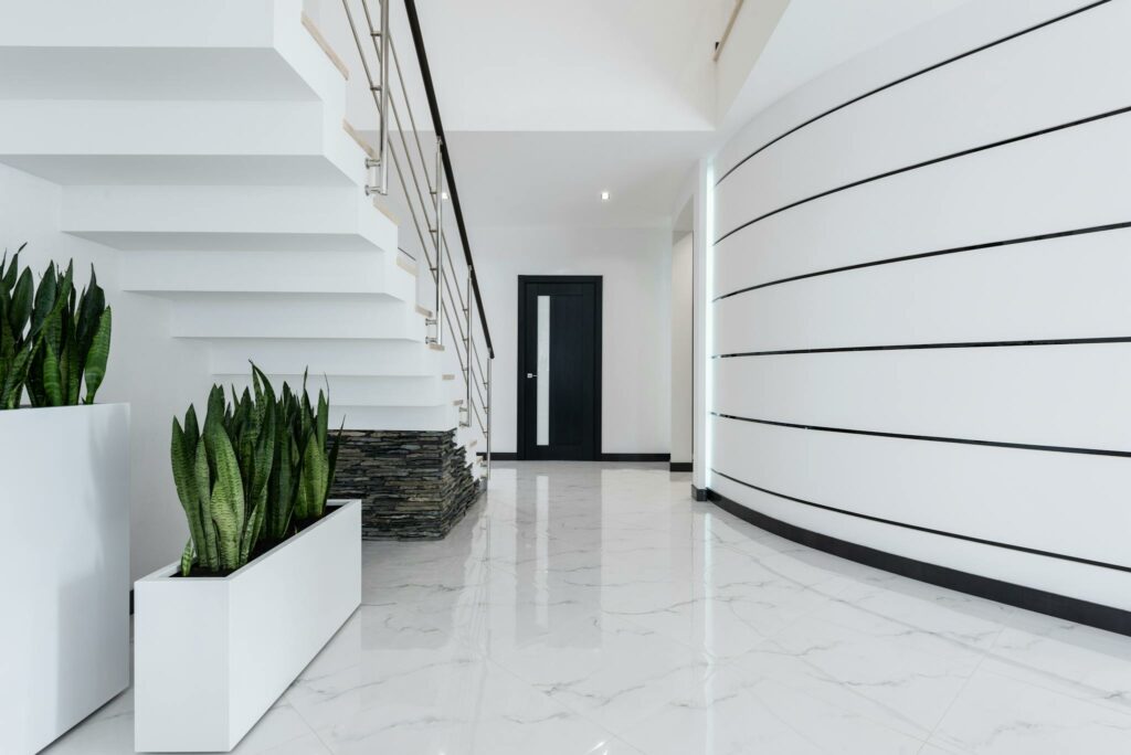 A contemporary and elegant interior featuring a stylish staircase and sleek design elements.